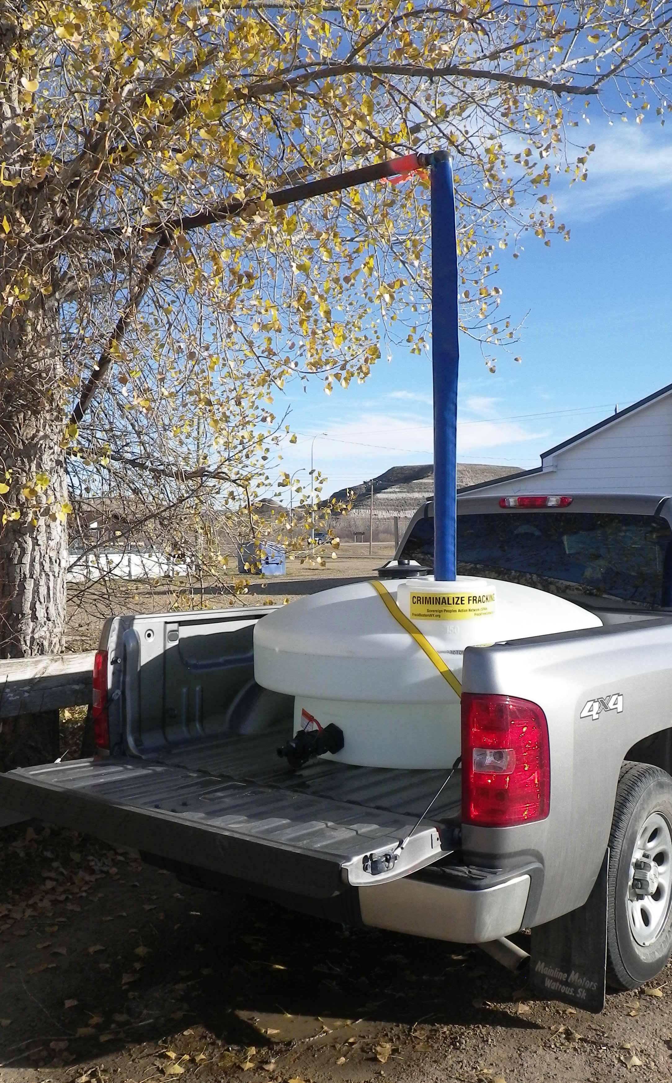 2015 10 21 Ernst hauling water from Rosedale, 45 minutes one way drive from Rosebud, NY criminalize fracing sticker on tank