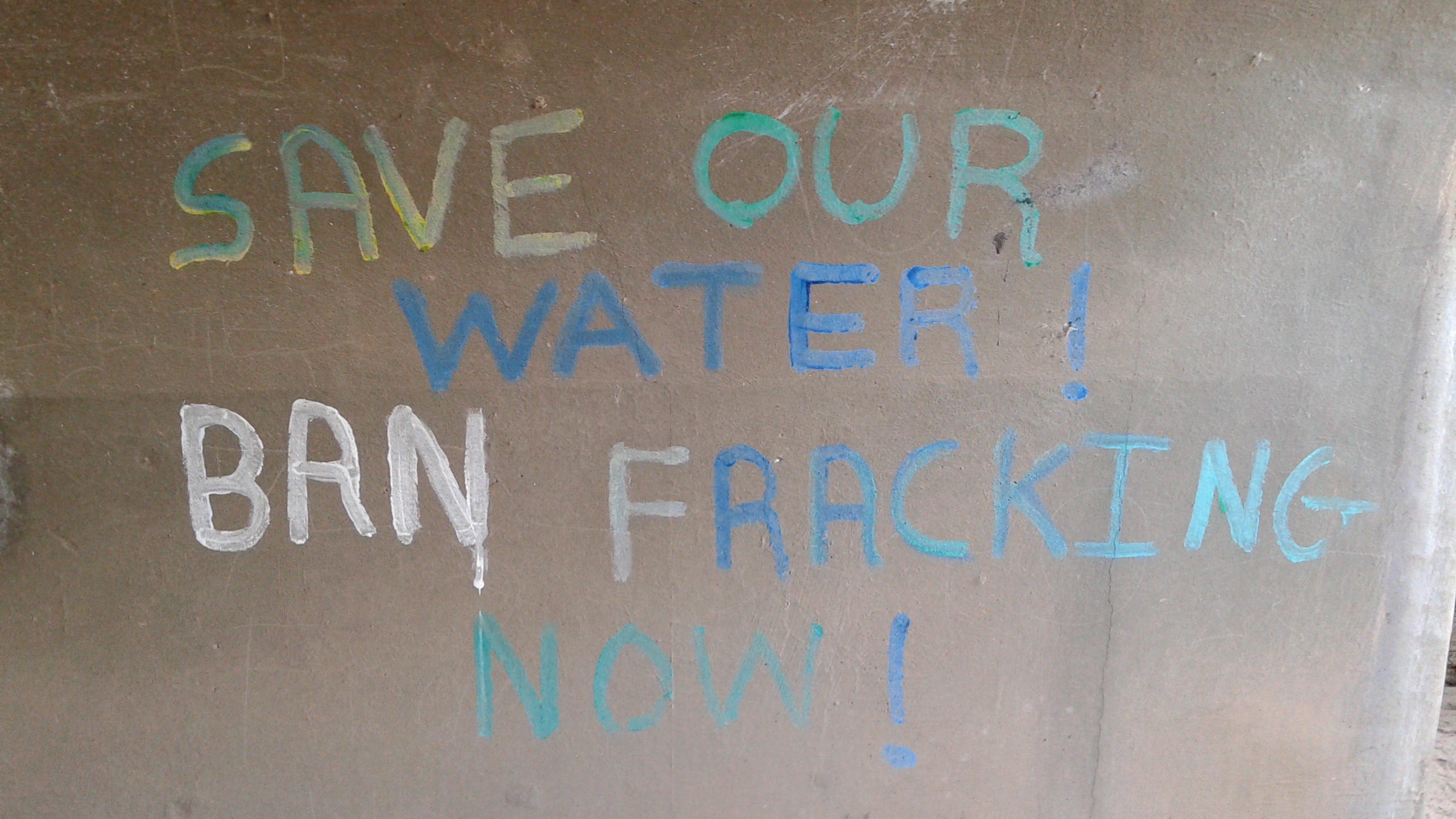2017 'Save our Water, Ban Fracking Now' painted underside of a bridge in heart of Trump Land, Arizona, USA