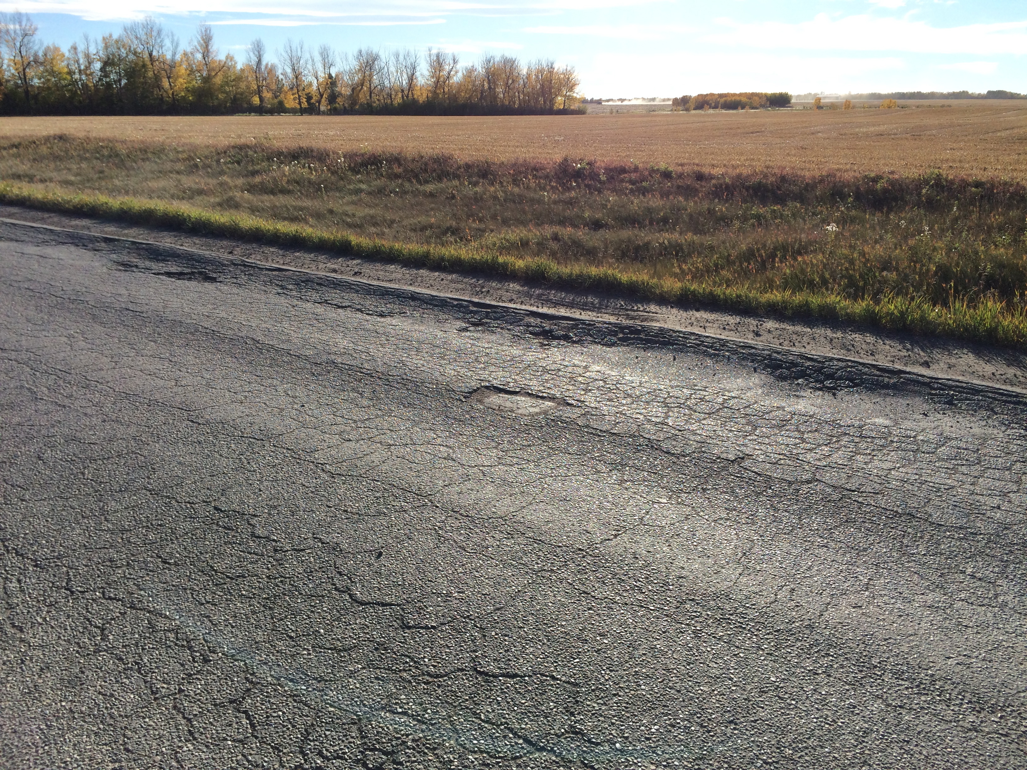 2016-09-27-road-damages-didsbury-hauling-toxic-oilfield-waste-to-waste-pile-at-didsbury-landfill-alberta