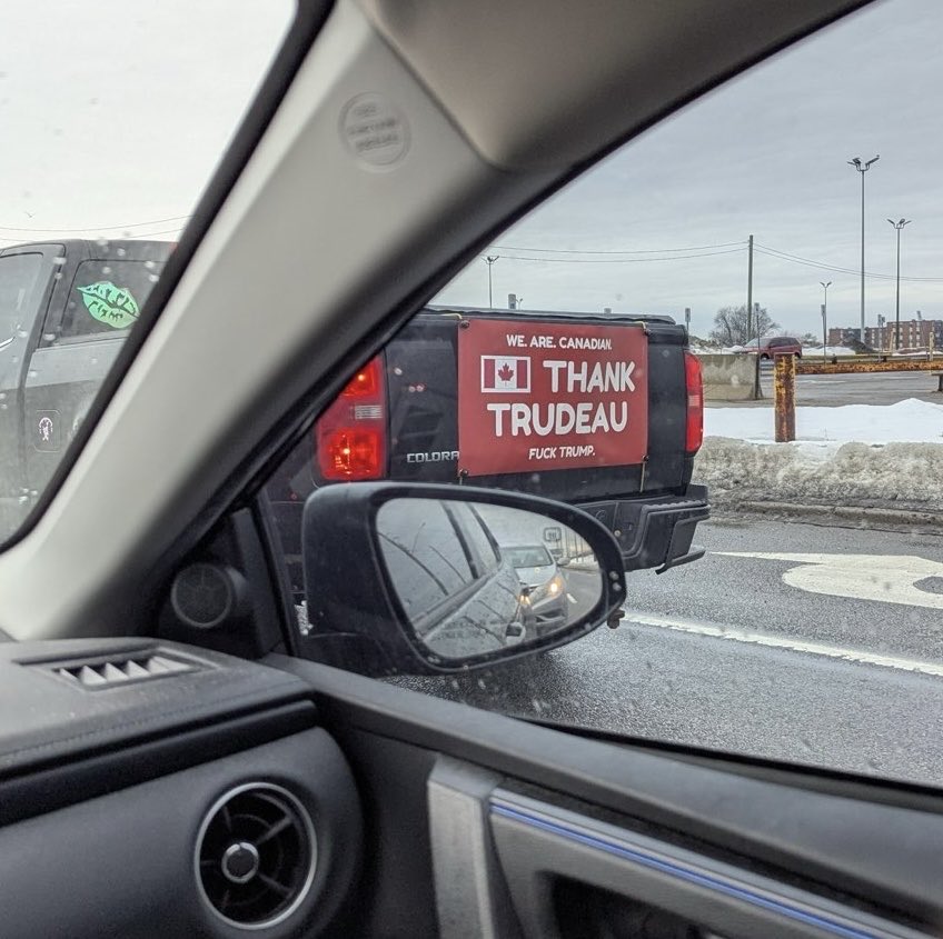 2025 03 05 Photo of a banner on a truck travelling on a highway near Ottawa Canada, that says, "We are Canadian. Thank Trudeau. Fuck Trump.'