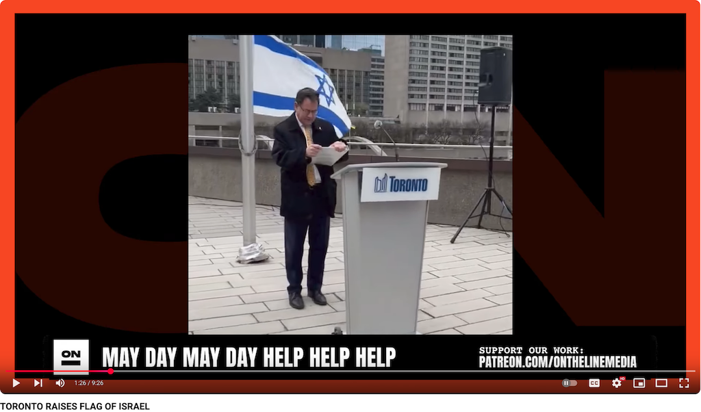 2025-05-02 on the line media reports on City of Toronto replacing the Canadian flag with Israel's, a flag of genocide, image shows a male councillor swaying and singing in front of the Israeli flag, behind a lecturn with "Toronto" on it.