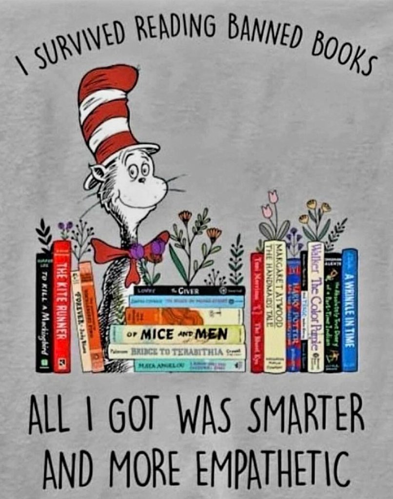 Cat in the hat (bright red and white striped top hat) wearing red and purple bow tie looking at us over a shelf of books, including A Wrinkle in Time, Of Mice and Men, The Colour Purple and more, Text on the poster says, I survived reading banned books. All I got was smarter and more empathetic.